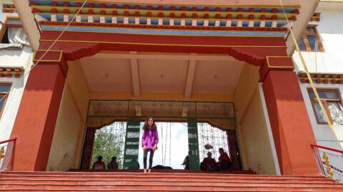 Felicia at the top of the stairs in a Buddhist temple she climbed